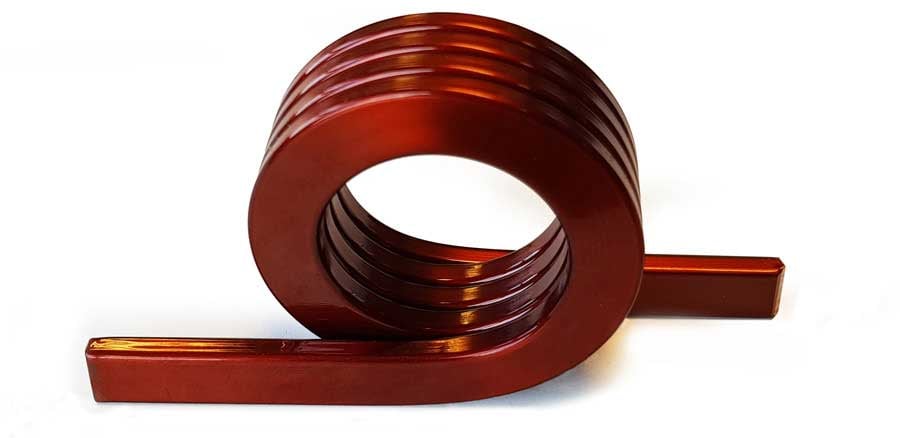 Edgewise winding is one of the modern trends in coil manufacturing. The principle of this winding technology is that the rectangular section wire is wound not on the flat part of the wire but on the short side of the wire. That’s where the terms edgewise winding or side-winding stands for.